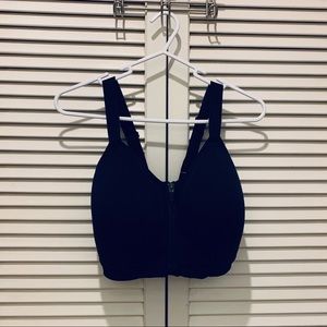 Black zip-front sports bra by Core 10